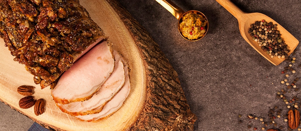 Tender and juicy pork loin roast	glazed with brown sugar pecan on top of a log.  Recipe calls for 6 ingredients, 105 minutes cooking time, 15 minutes prep time, and 8 servings.