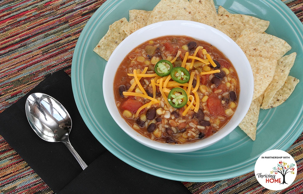 Bowl of salsa with black beans, diced tomatoes, diced green chiles, corn, and brown rice next to a dish of tortilla chips.  Recipe calls for 10 ingredients, 15 minutes cooking time, and 8 servings.