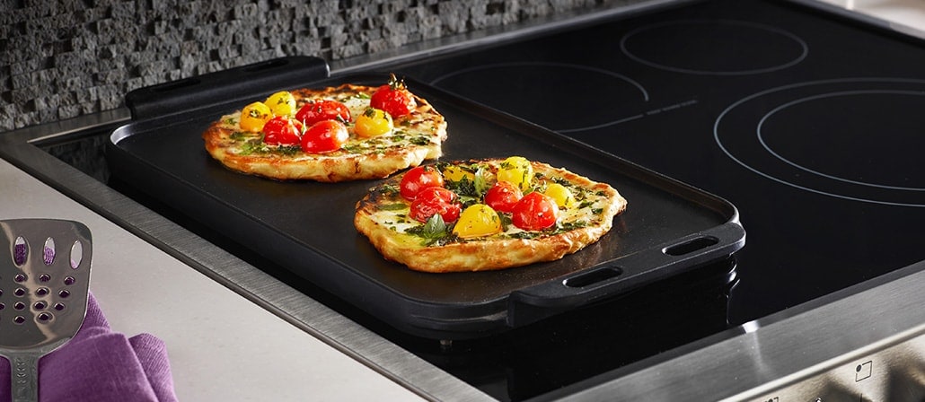 Cooked Tomato, Burrata, & Herb Flatbread with Cherry Tomatoes in a griddle on a stovetop.  Recipe calls for 9 ingredients, 25 minutes cooking time, 15 minutes prep time, and 4 servings.