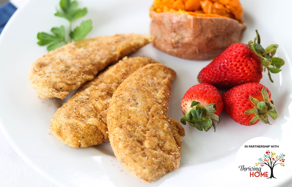 Oven-Fried Chicken Tenders with strawberries on a plate.  Recipe calls for 7 ingredients, 15 minutes cooking time, 5 minutes prep time, and 4 servings.