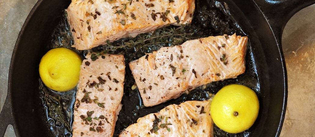 Seared Salmon with lemons in a cast iron skillet.  Recipe calls for 11 ingredients, 30 minutes cooking time, 15 minutes prep time, and 4 servings.