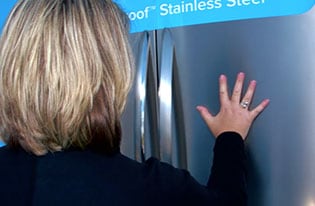No More Fingerprints!- Potential consumers at a showcase are allowed to touch different Frigidaire Gallery stainless steel refrigerators and realize that their fingerprints don't show.