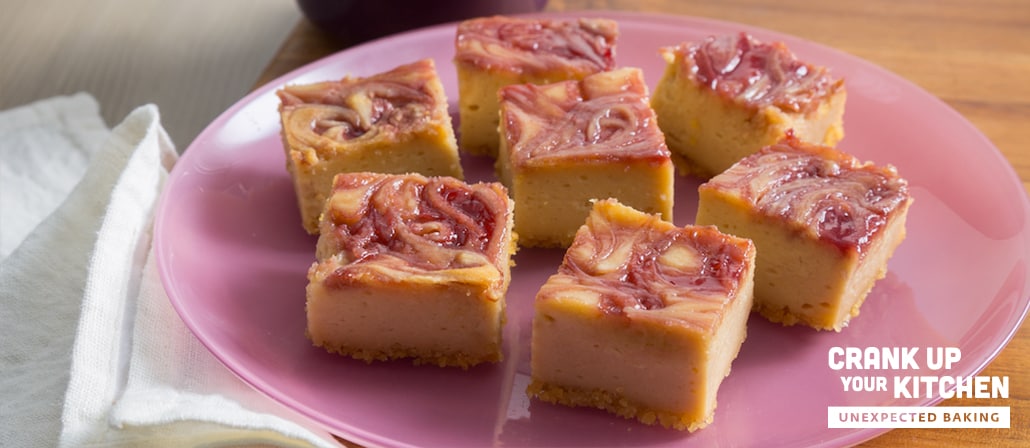 Peanut Butter and Jelly Cheesecake Bars with a Potato Chip Crust on a plate.  Recipe calls for 11 ingredients, 55 minutes cooking time, 15 minutes prep time, and 9 servings.